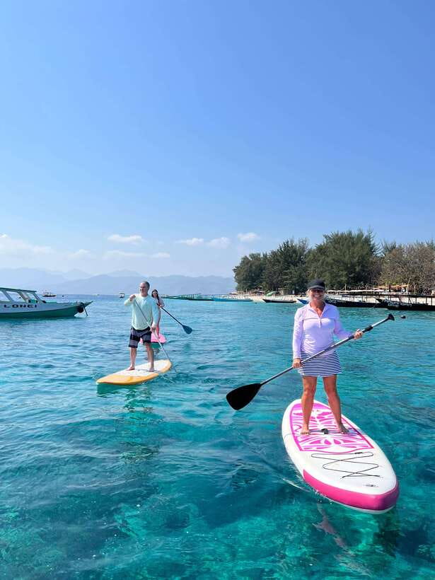 gili sunrise Stand-up paddle boarding or kayaking (droneshot - Paddling toward Gili Meno