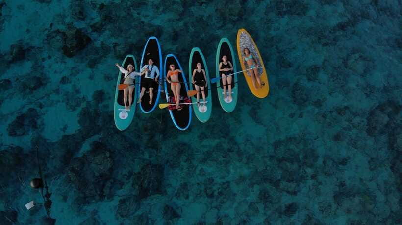 gili sunrise Stand-up paddle boarding or kayaking (droneshot - Drone photos and the young coconut finish