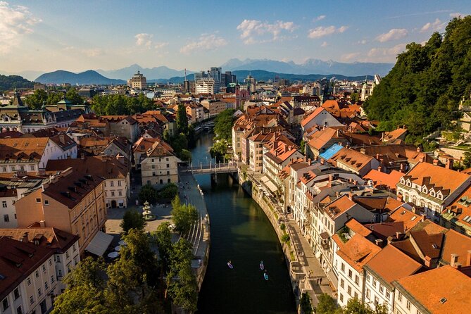Ljubljana Stand-Up Paddle Boarding Lesson and Tour - Passing the Triple Bridge from the river