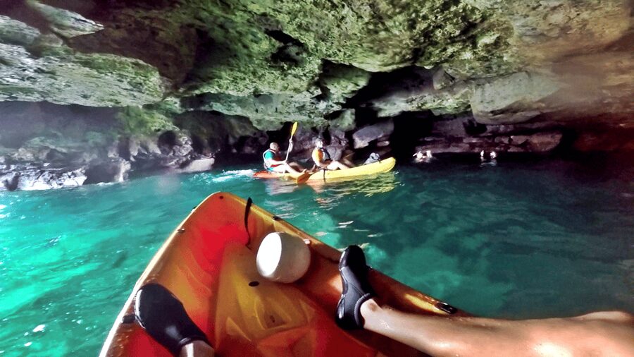 Mogán: Guided Kayak to Caves and Snorkeling Tour - Paddling out beneath the white cliffs