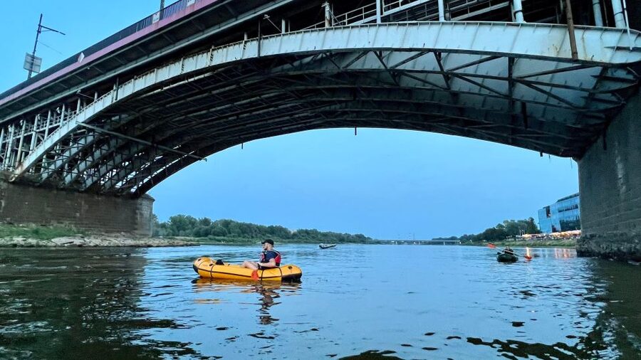 Packrafting kayaking guided tour Vistula river Warsaw Poland - Old Town at Sunset From the River