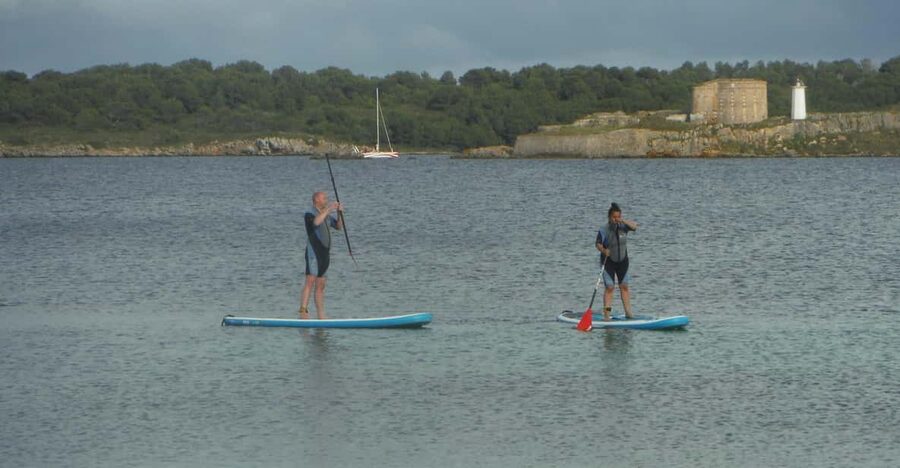 Rent A Stand Up Paddle - Paddling into calm Fornells Bay