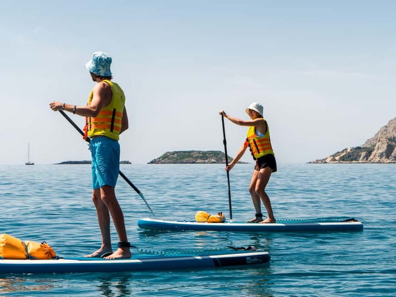 Rhodes: Stegna Beach Stand Up Paddleboarding Lesson - From kneeling to standing on the paddleboard