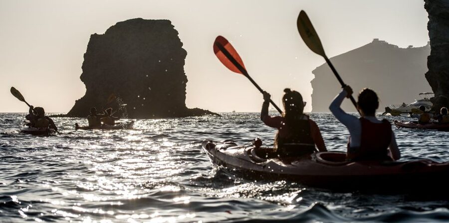 Santorini: Sunset Sea Kayak with Light Dinner - Mesa Pigadia to White Beach, with cliffs overhead