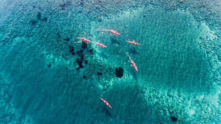 Santorini: Sunset Sea Kayak with Light Dinner - Caves and the Black Mountain sunset